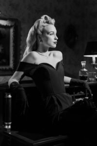 Stunning noir-style portrait of an elegant woman exuding classic 1950s allure.